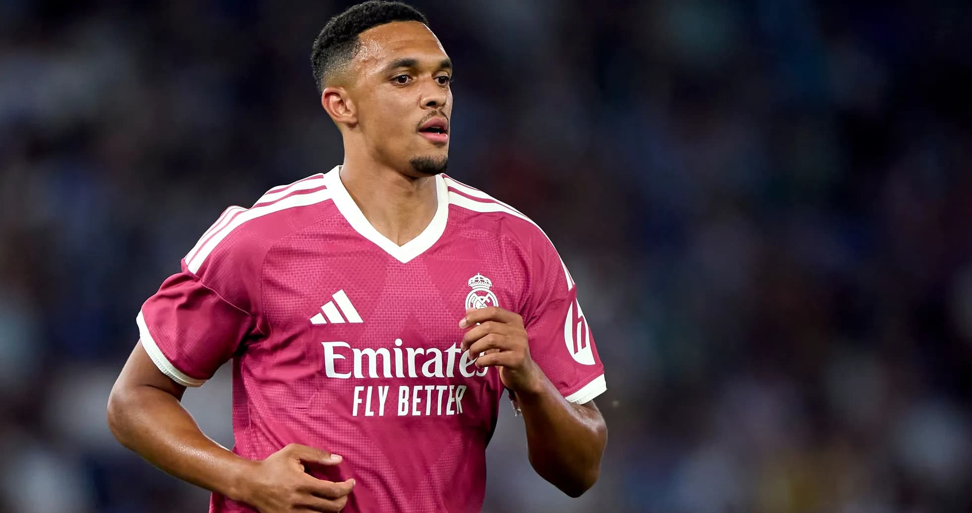 Player running in pink Real Madrid jersey