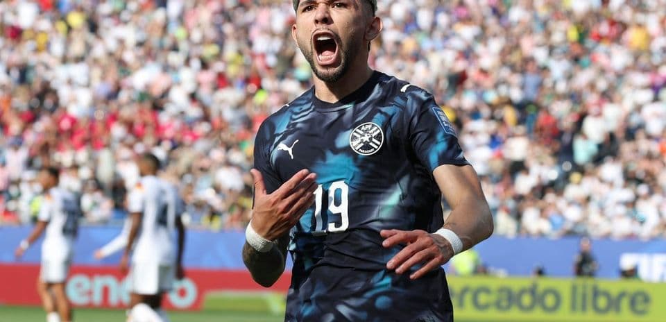 Player celebrating a goal in a packed stadium