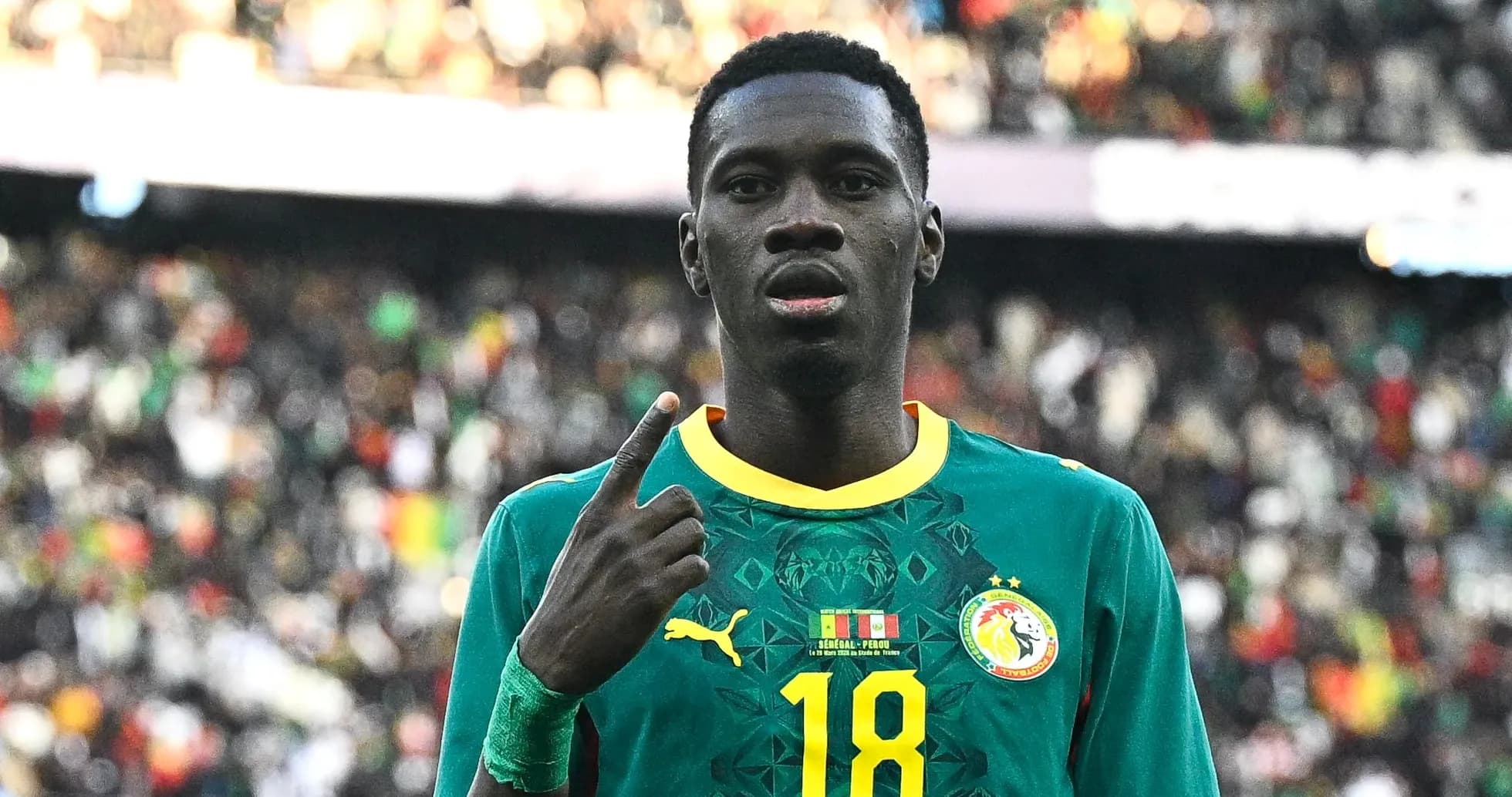 Senegal player celebrating with finger raised during match