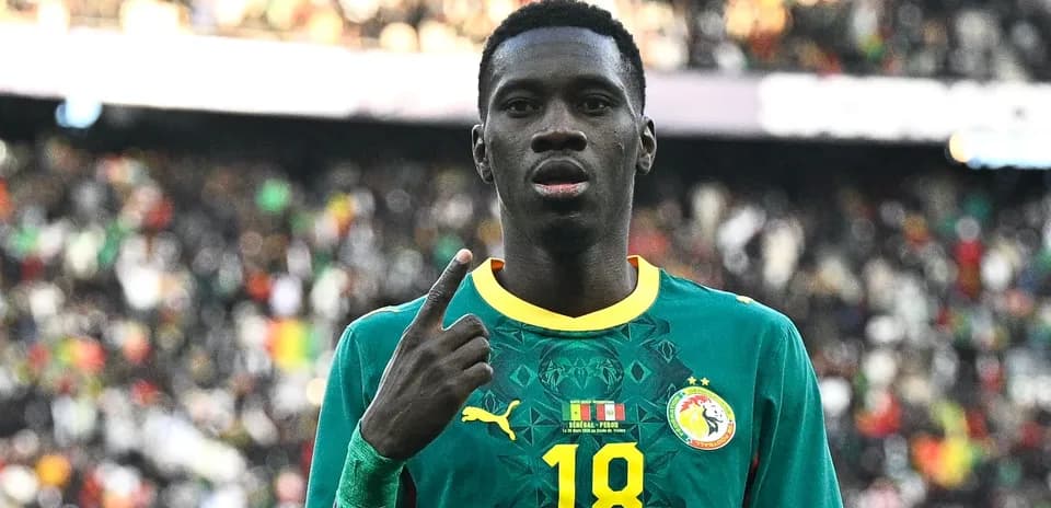 Senegal player celebrating with finger raised during match