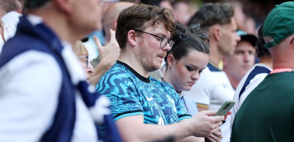 Fans in stadium looking at their phones