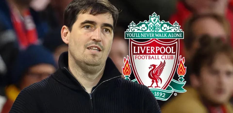 Person in front of Liverpool FC logo at match