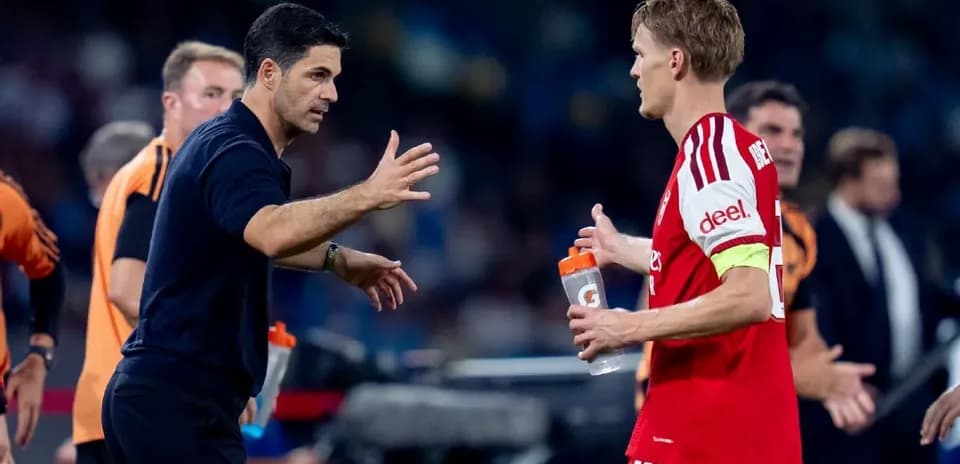 Manager discussing strategy with player on sidelines