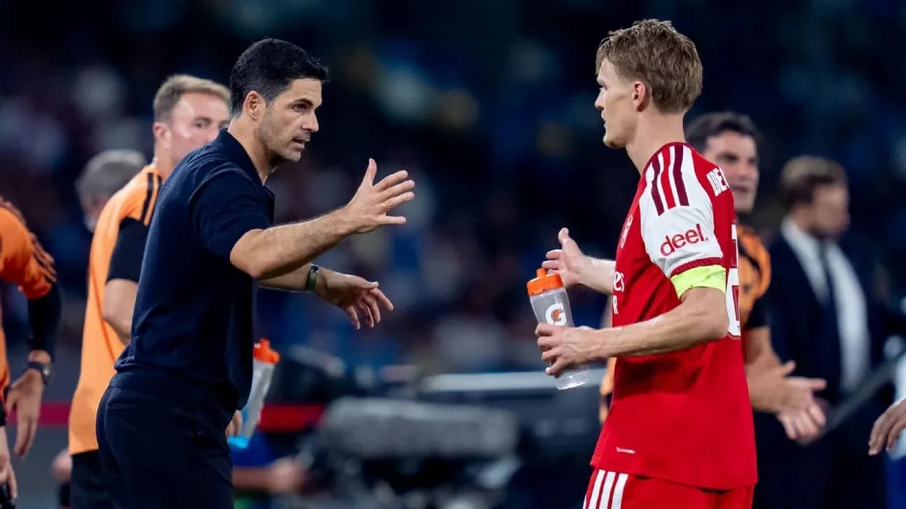 Manager discussing strategy with player on sidelines