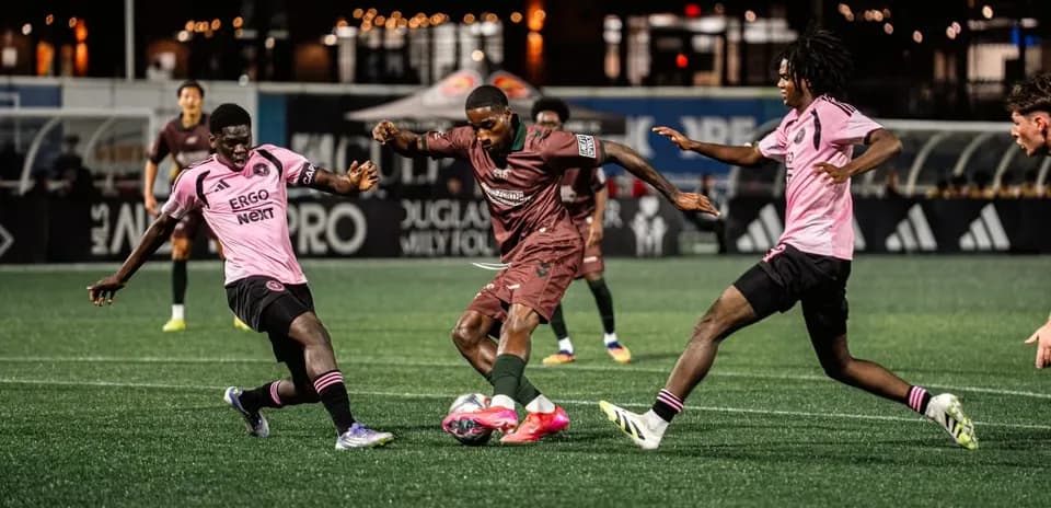Players competing for the ball in MLS Next Pro match