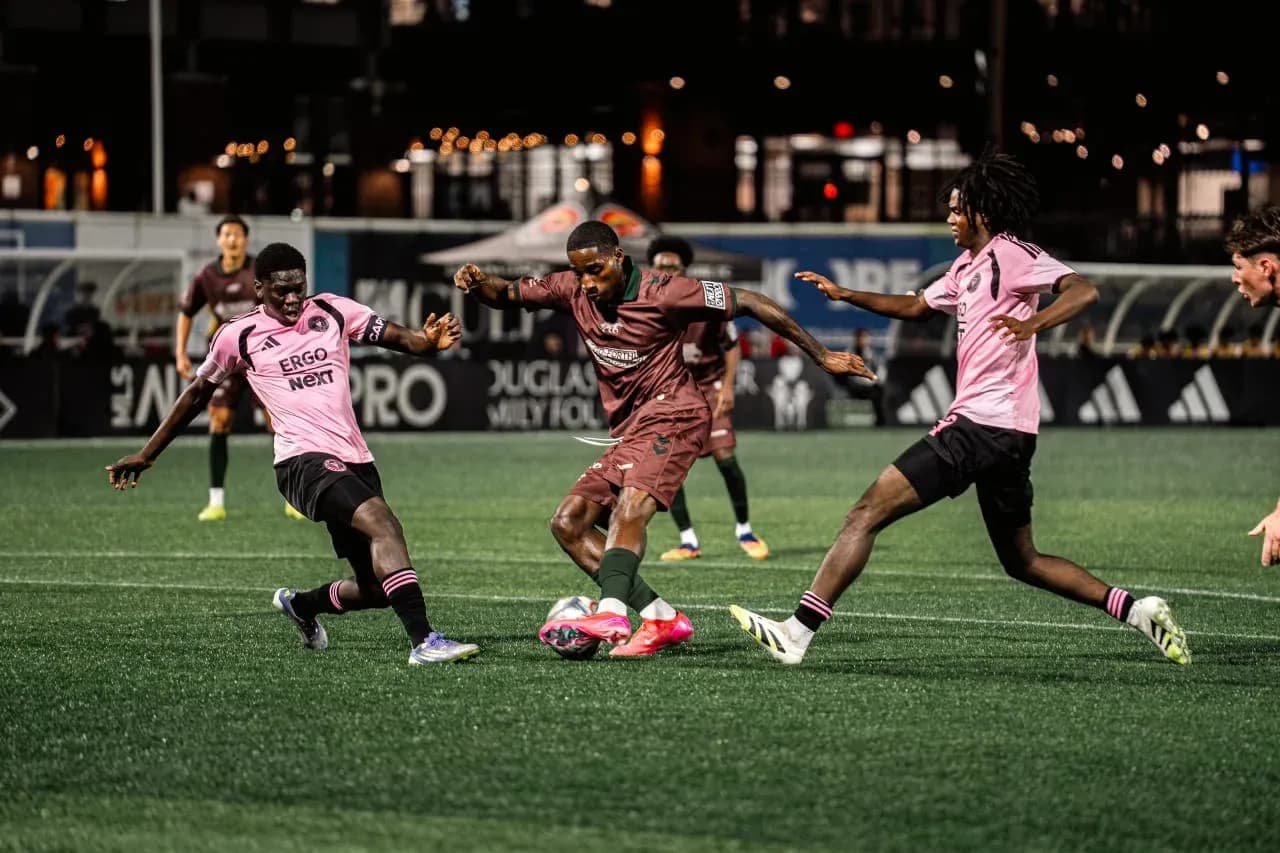 Players competing for the ball in MLS Next Pro match