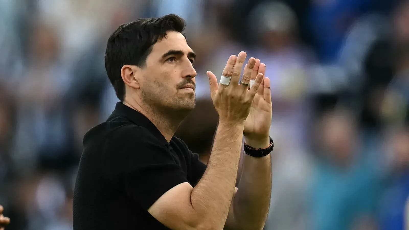 Coach applauding during a match celebration
