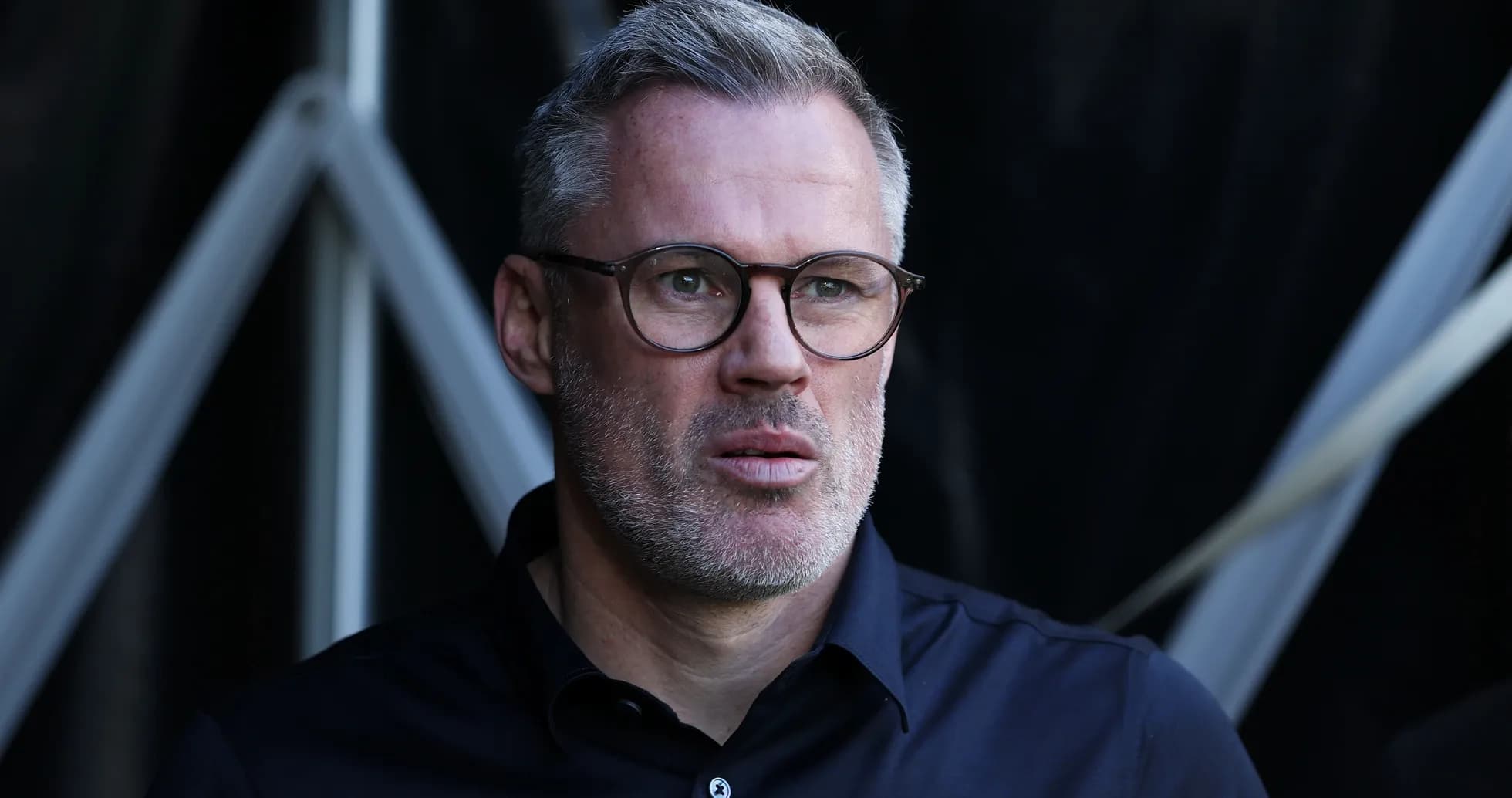 Man with glasses looking thoughtfully at event
