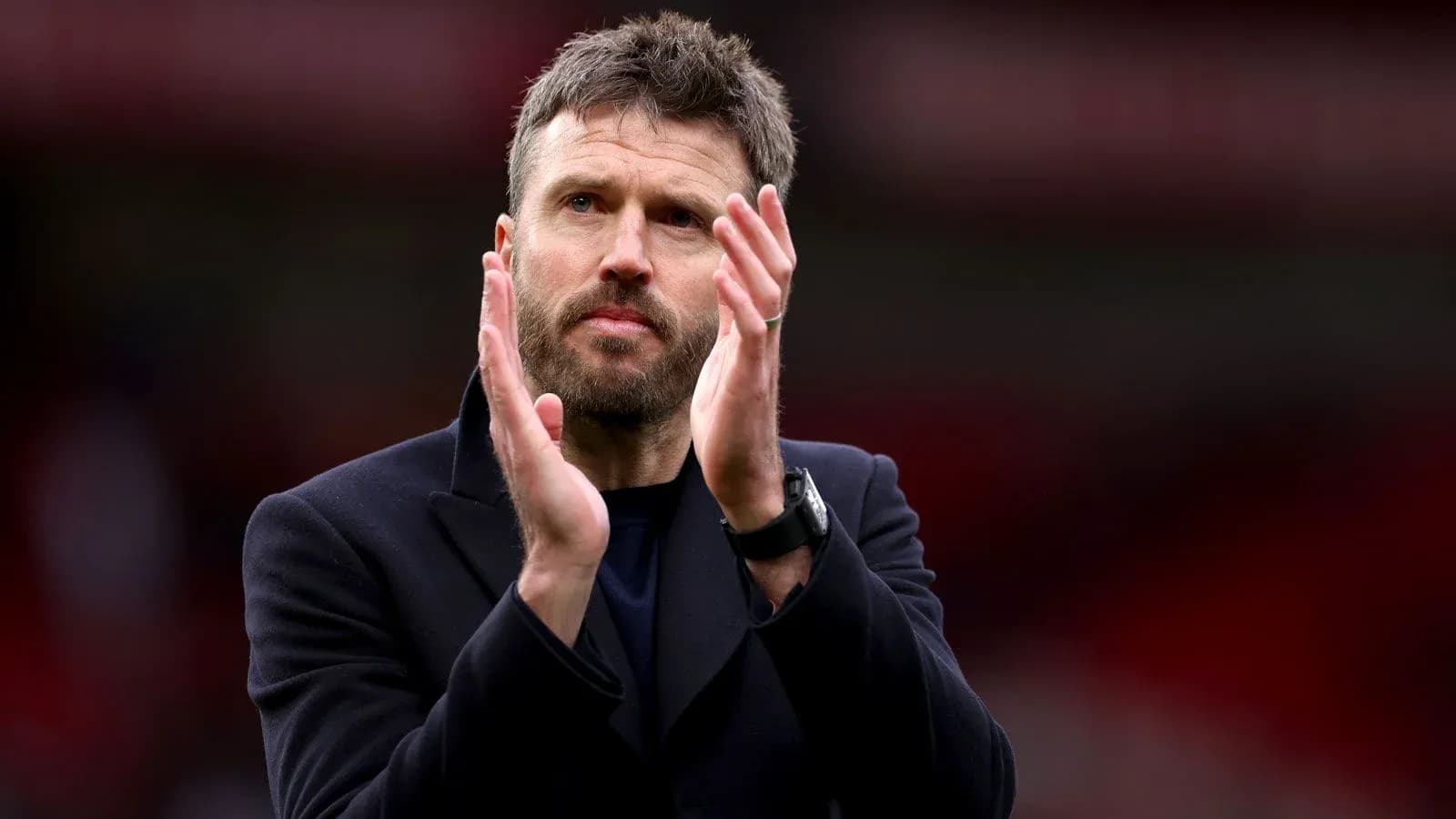 Coach applauding fans after a match