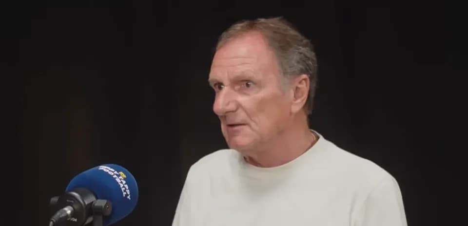 Person speaking into a microphone during interview
