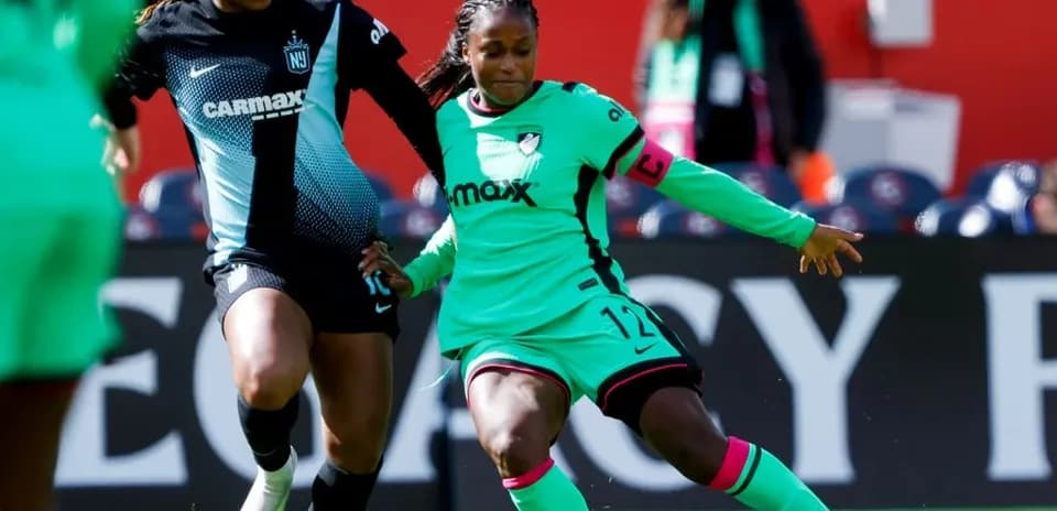 Two players competing for the ball in NWSL match