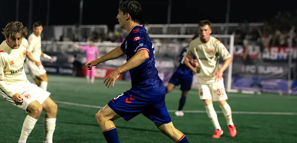 Cavalry FC player dribbling against Supra du Quebec