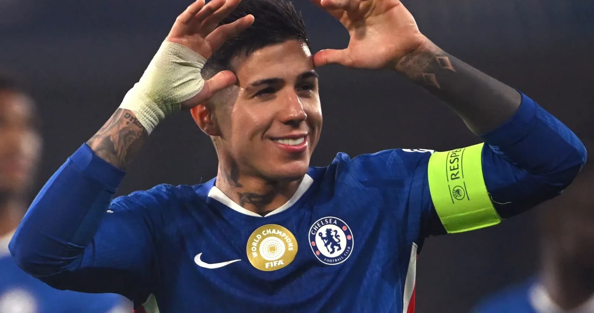 Chelsea player celebrating with hands raised