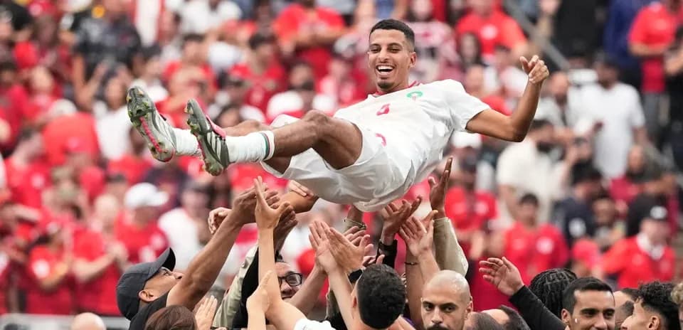 Player being lifted by teammates in celebration