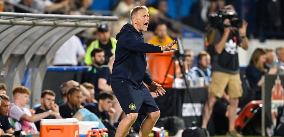 Coach instructing players from the sidelines during match