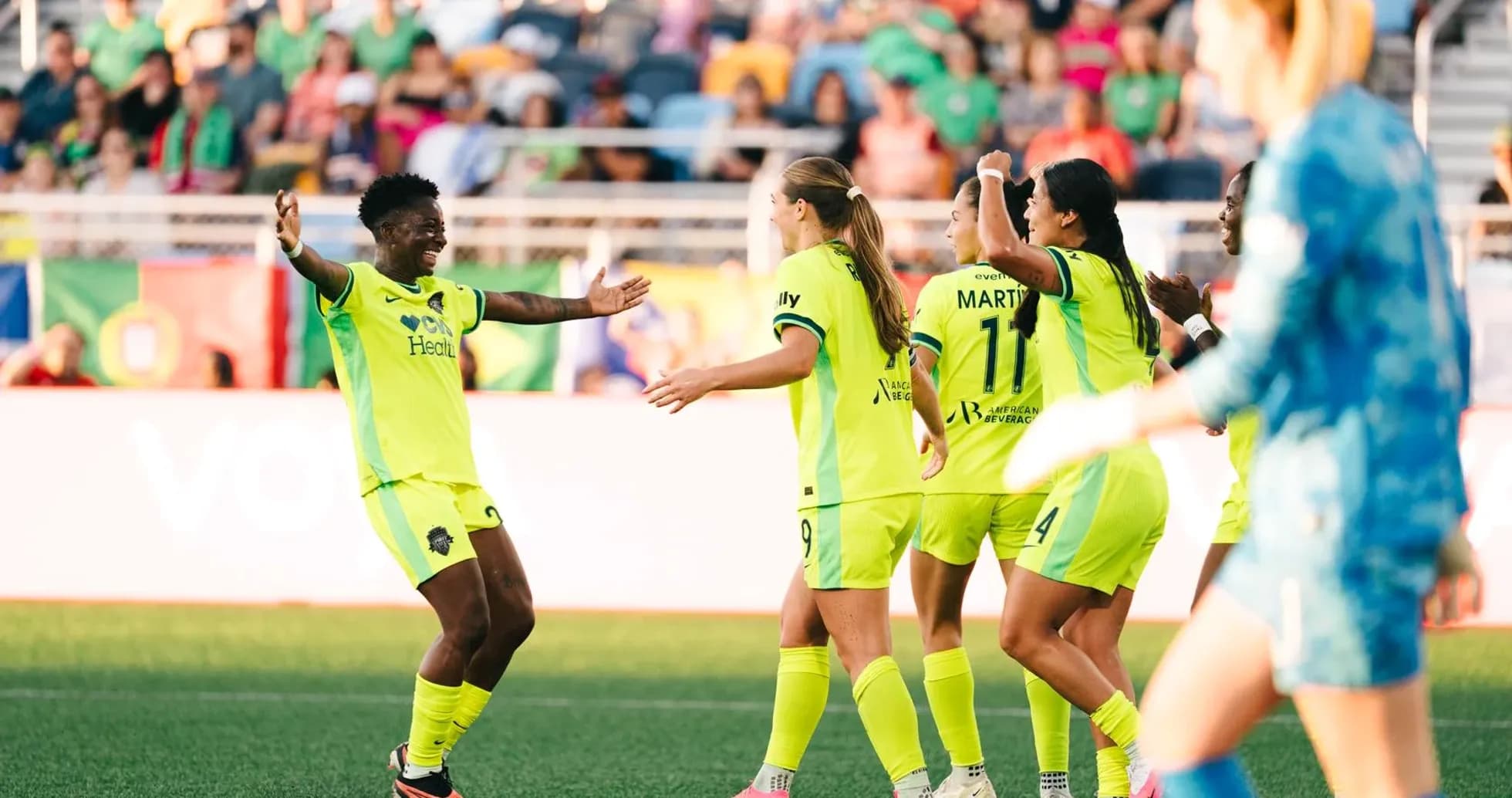Players celebrating a goal during NWSL match