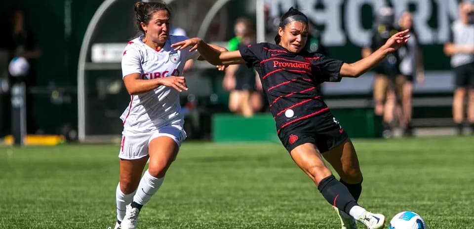 Player tackles opponent during NWSL match