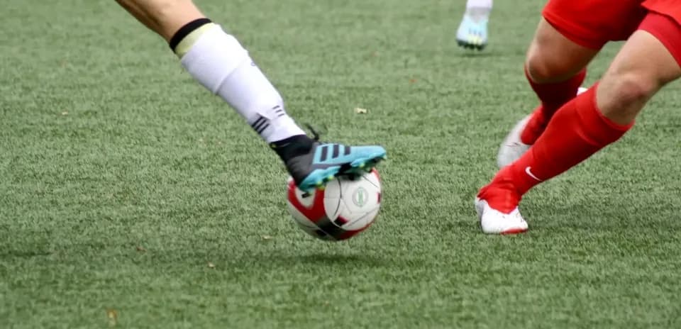 Players contesting for the ball during match