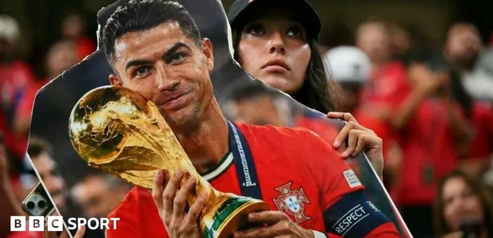 Fan holding cutout of Cristiano Ronaldo with trophy