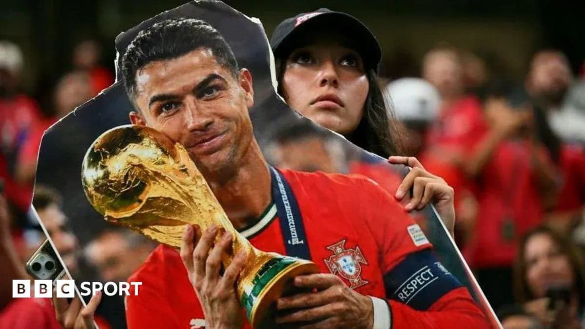 Fan holding cutout of Cristiano Ronaldo with trophy