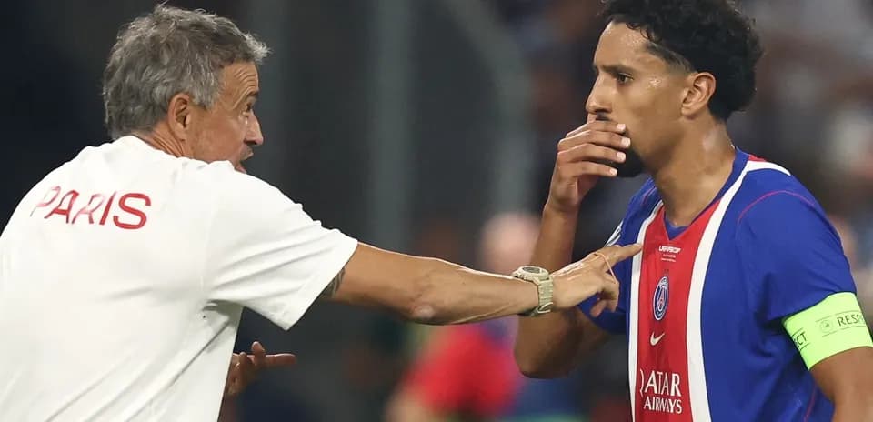 Coach discussing strategy with player on field