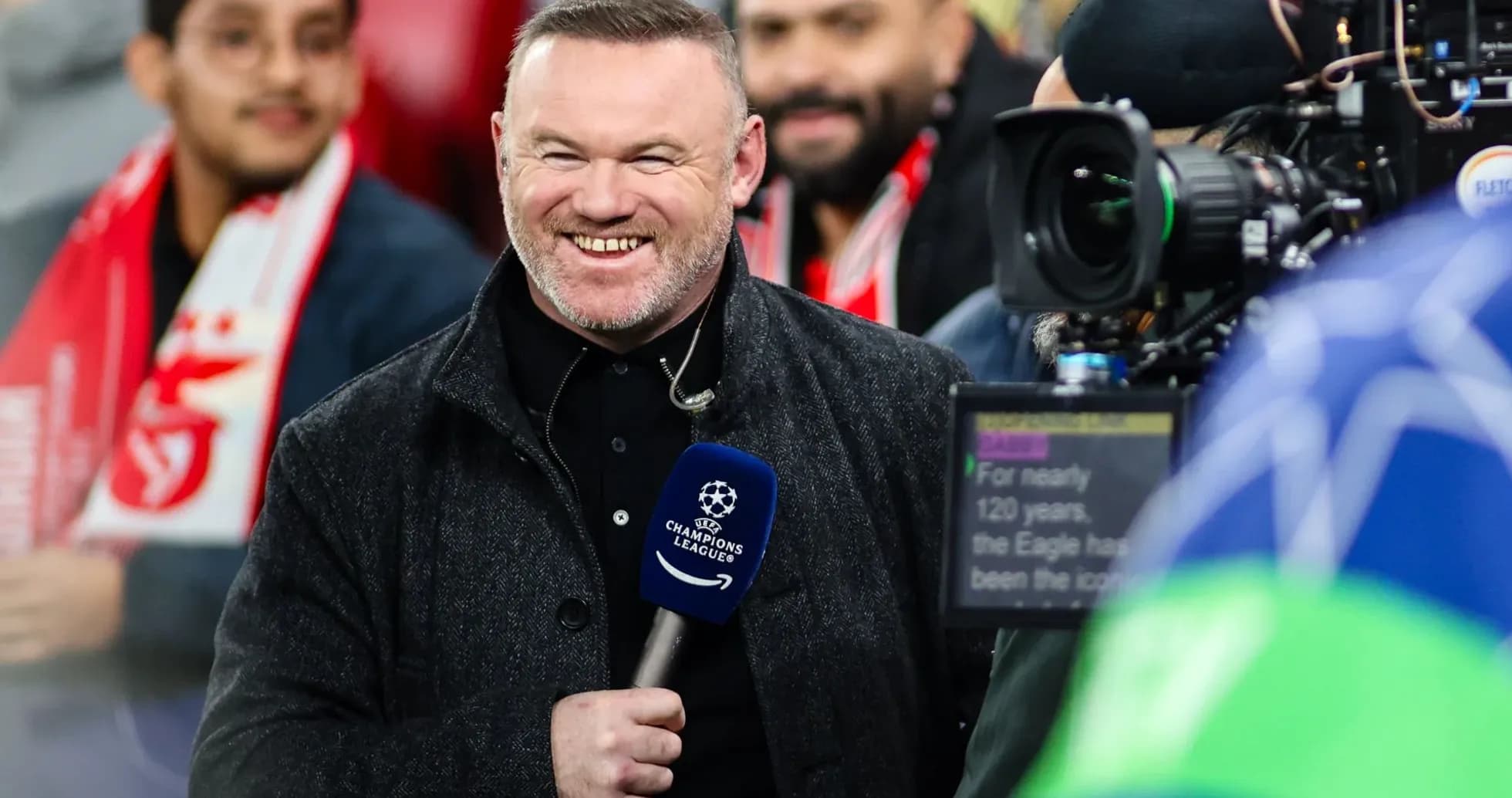 Presenter smiling while reporting at football match