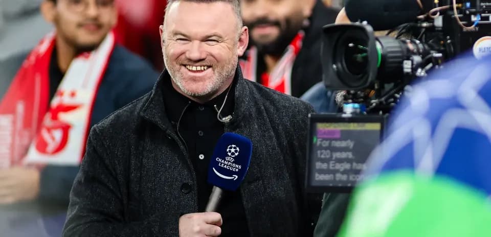 Presenter smiling while reporting at football match
