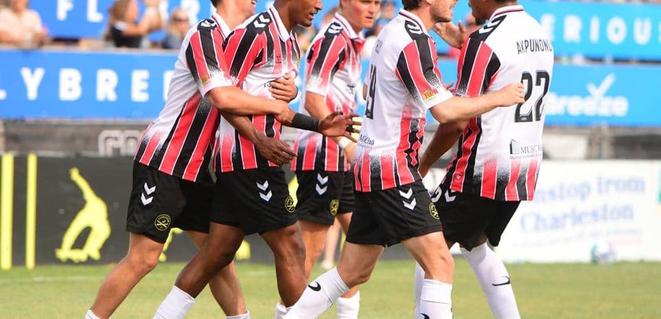 Players celebrating a goal during match