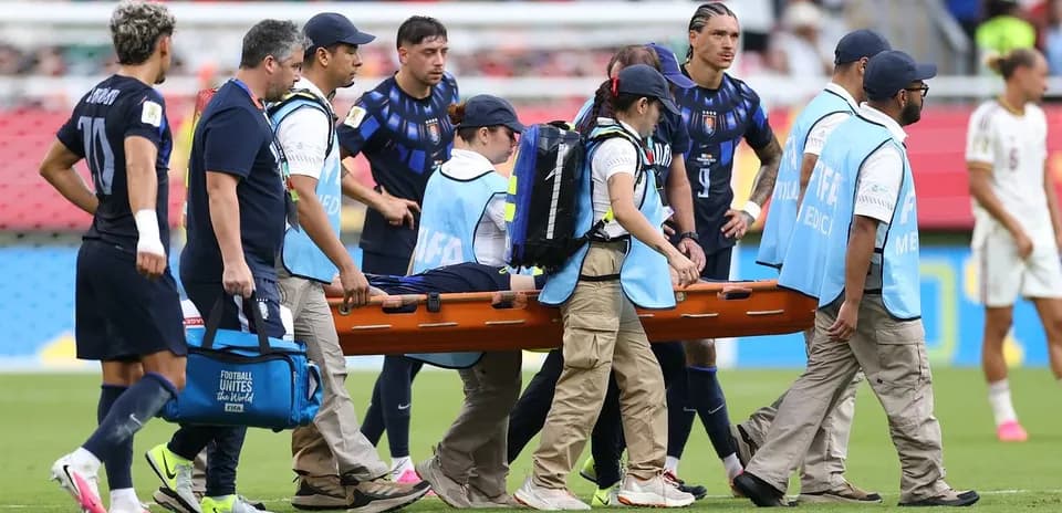 Medical team carrying injured player on stretcher