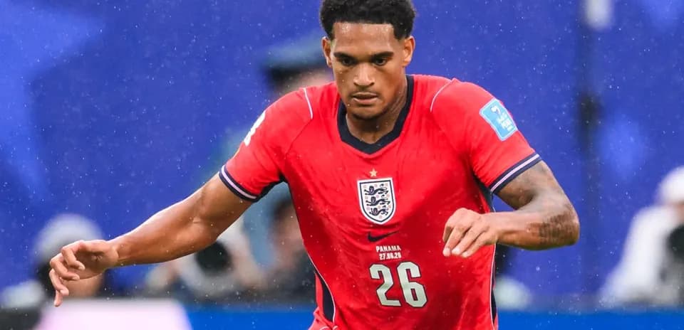 Player in red England jersey running during match
