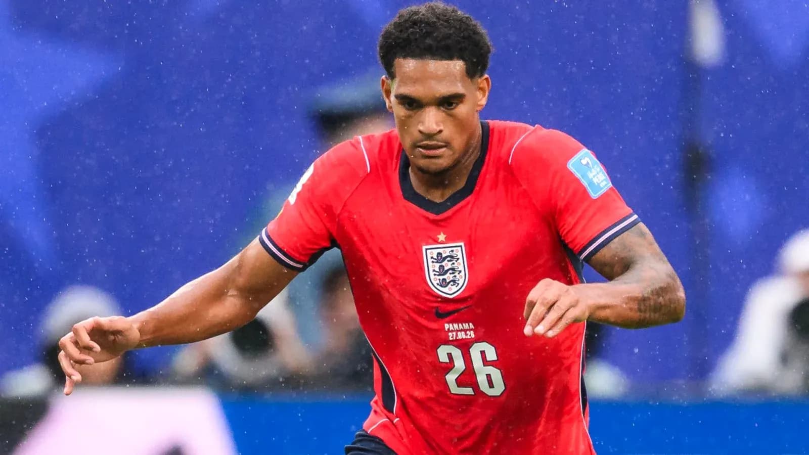 Player in red England jersey running during match