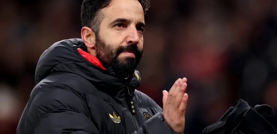 Coach applauding fans in stadium after match