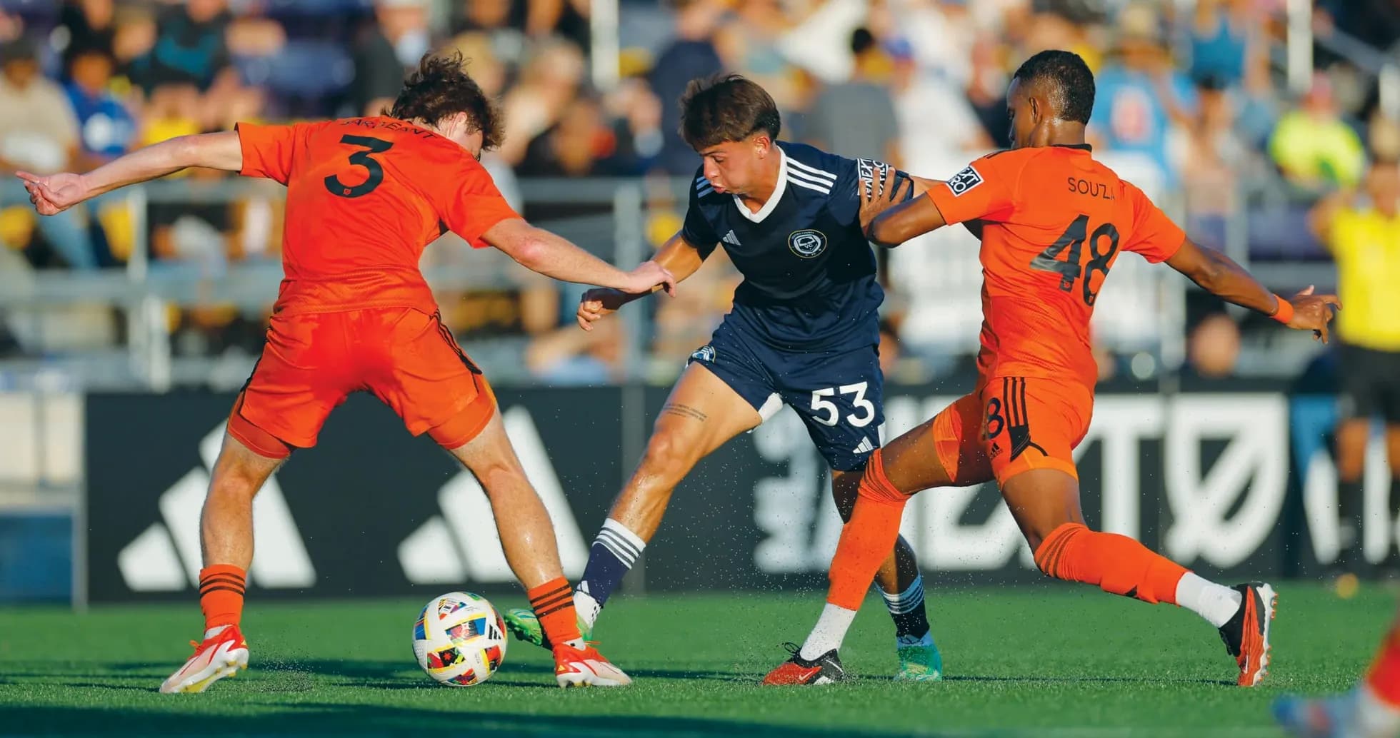 Two players contesting the ball during match