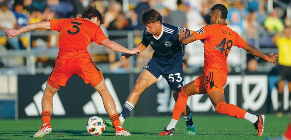 Two players contesting the ball during match