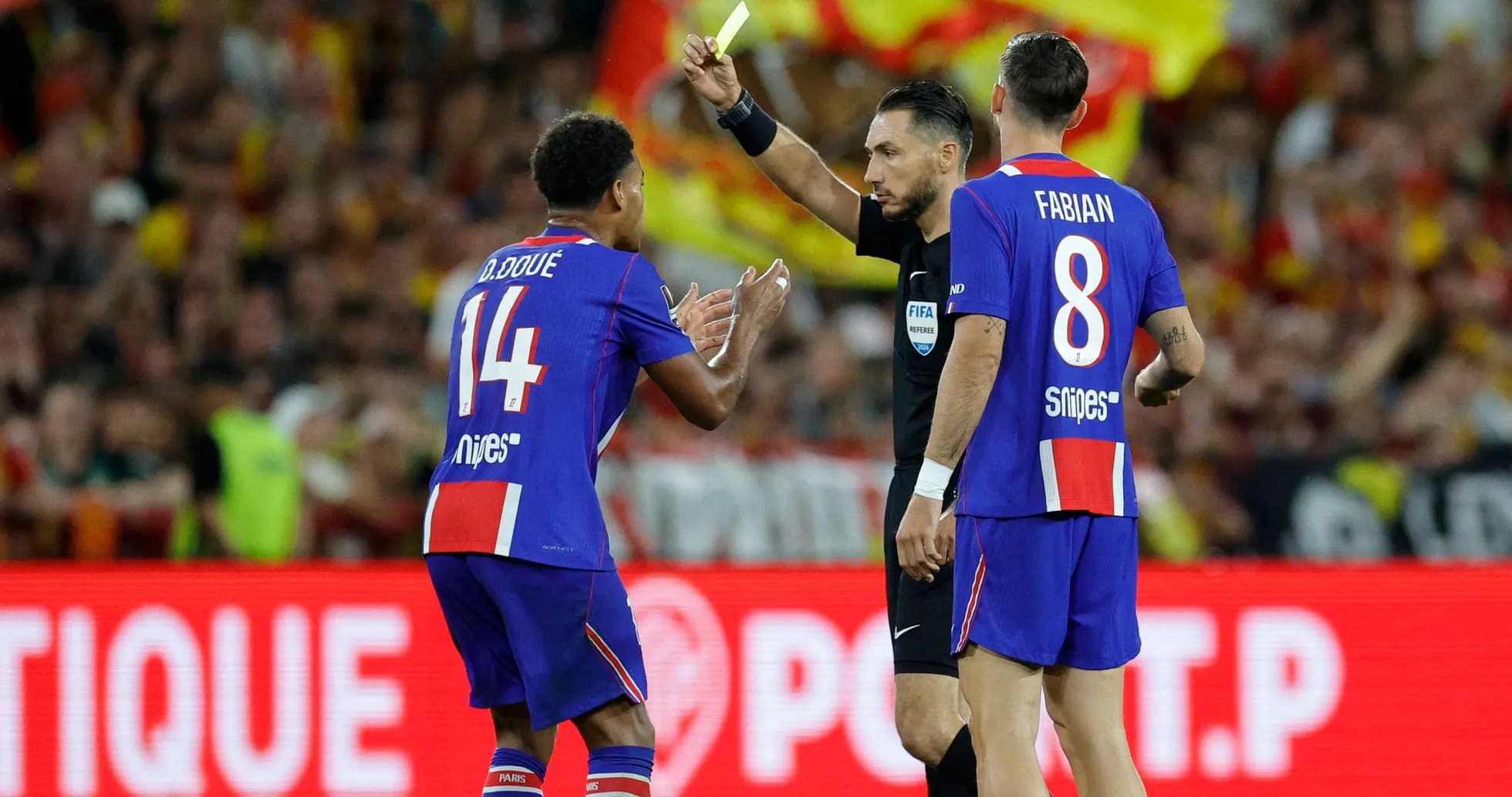 Referee showing yellow card to player during match