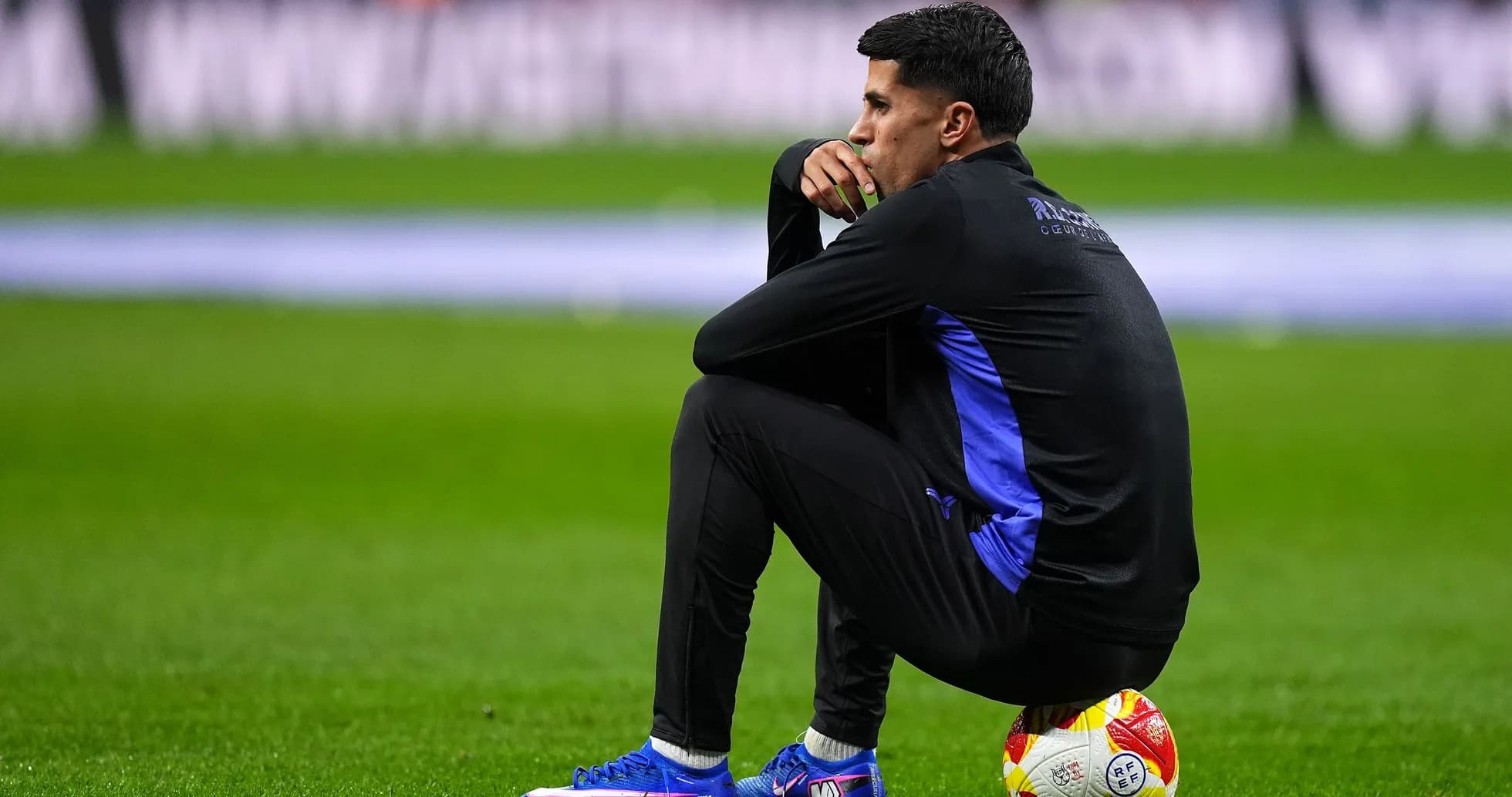 Player sitting on the pitch with a ball