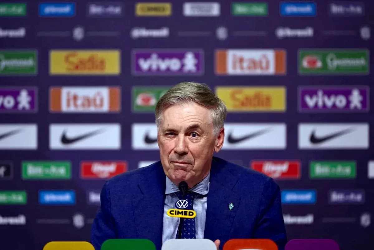 Coach speaking at press conference with sponsor backdrop