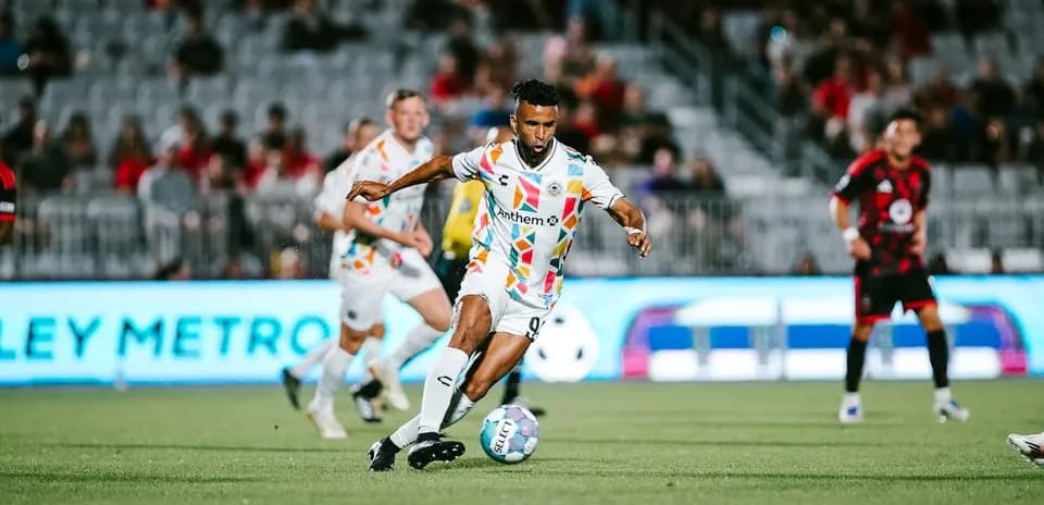 Player dribbling the ball in football match