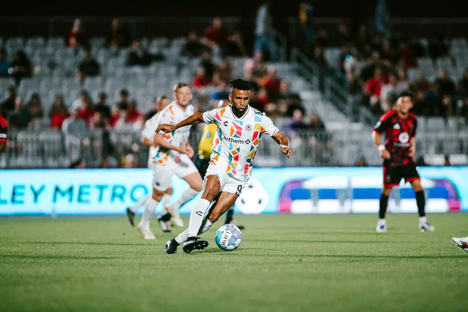 Player dribbling the ball in football match