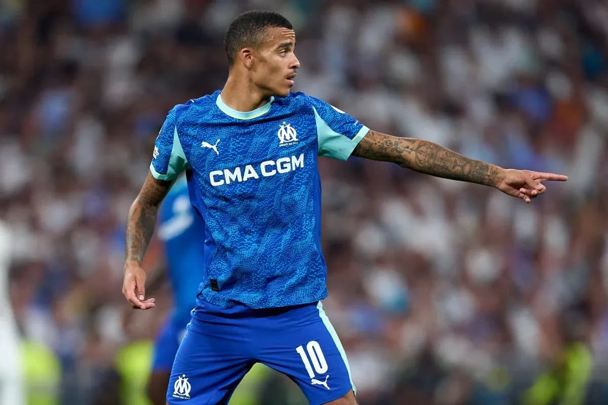 Player in blue Marseille kit directing teammates on field