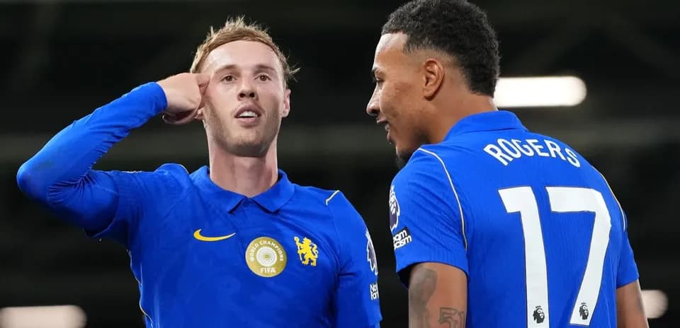 Two players celebrating a goal on the pitch