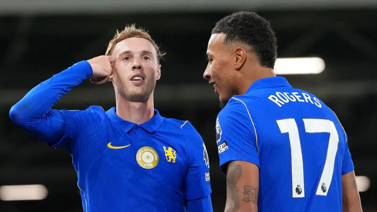 Two players celebrating a goal on the pitch
