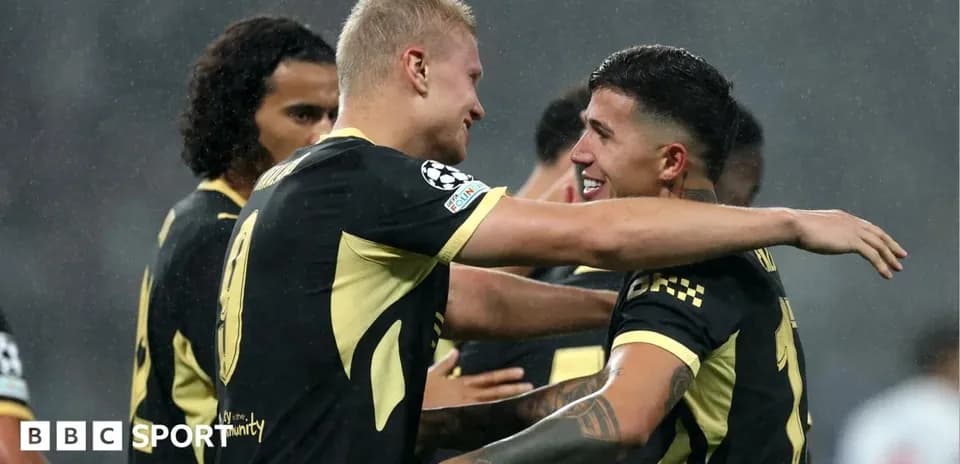 Two players celebrating a goal together on field