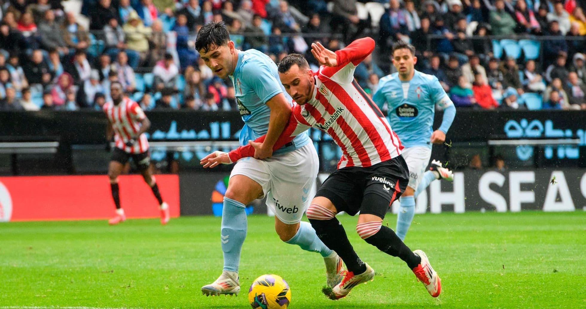 Athletic Club player battling for the ball
