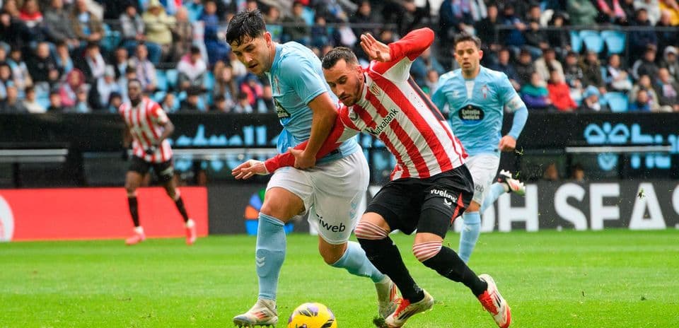 Athletic Club player battling for the ball