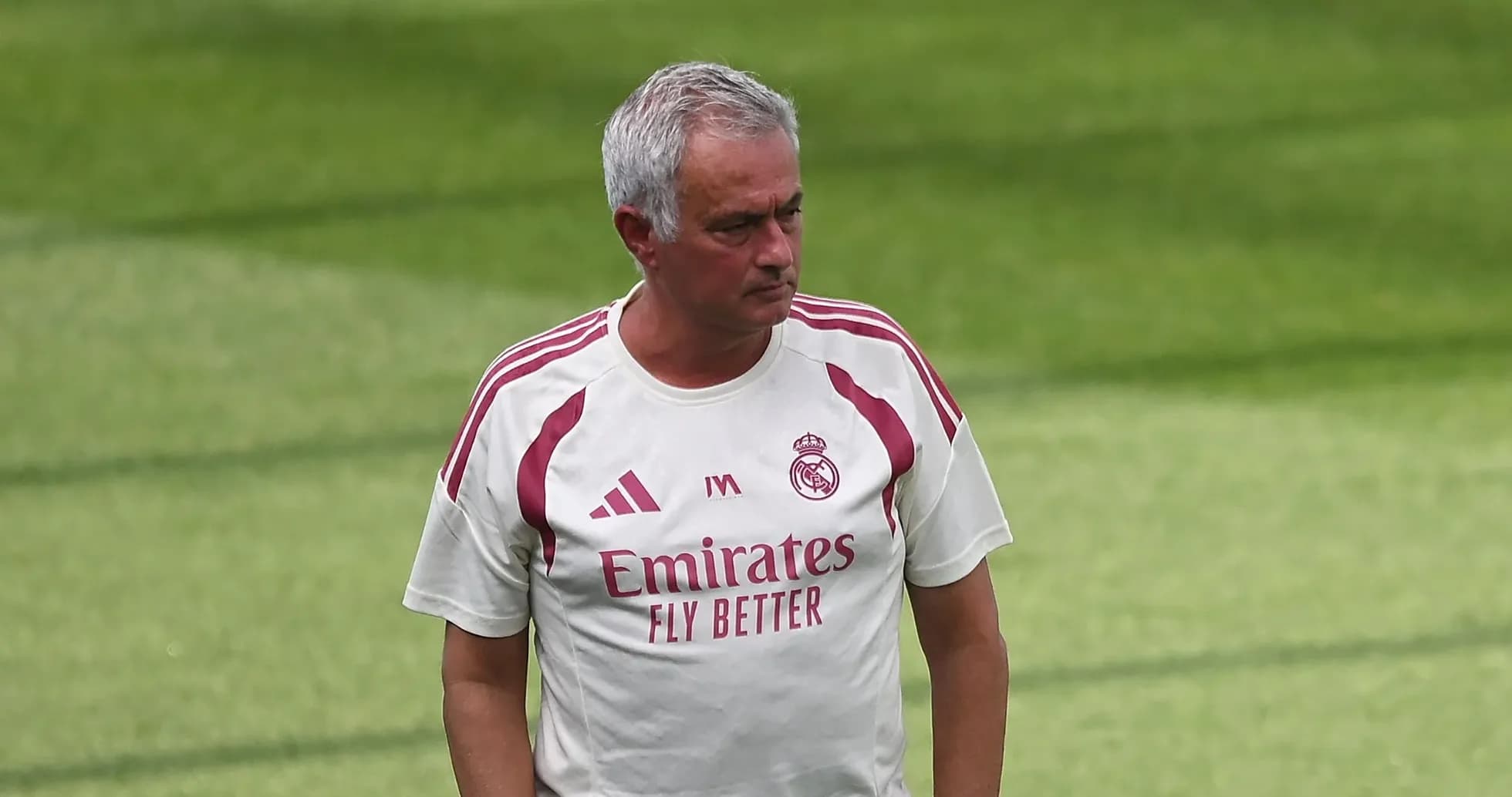 Coach walking on training pitch during session