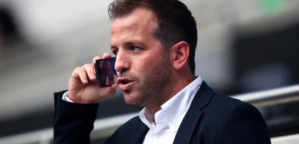Person talking on a mobile phone in a stadium