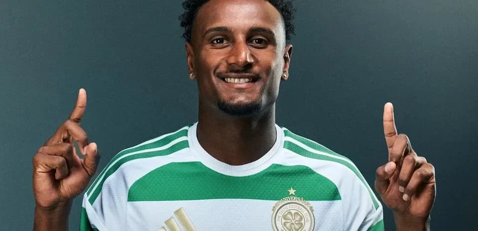 Player in green and white jersey pointing upwards