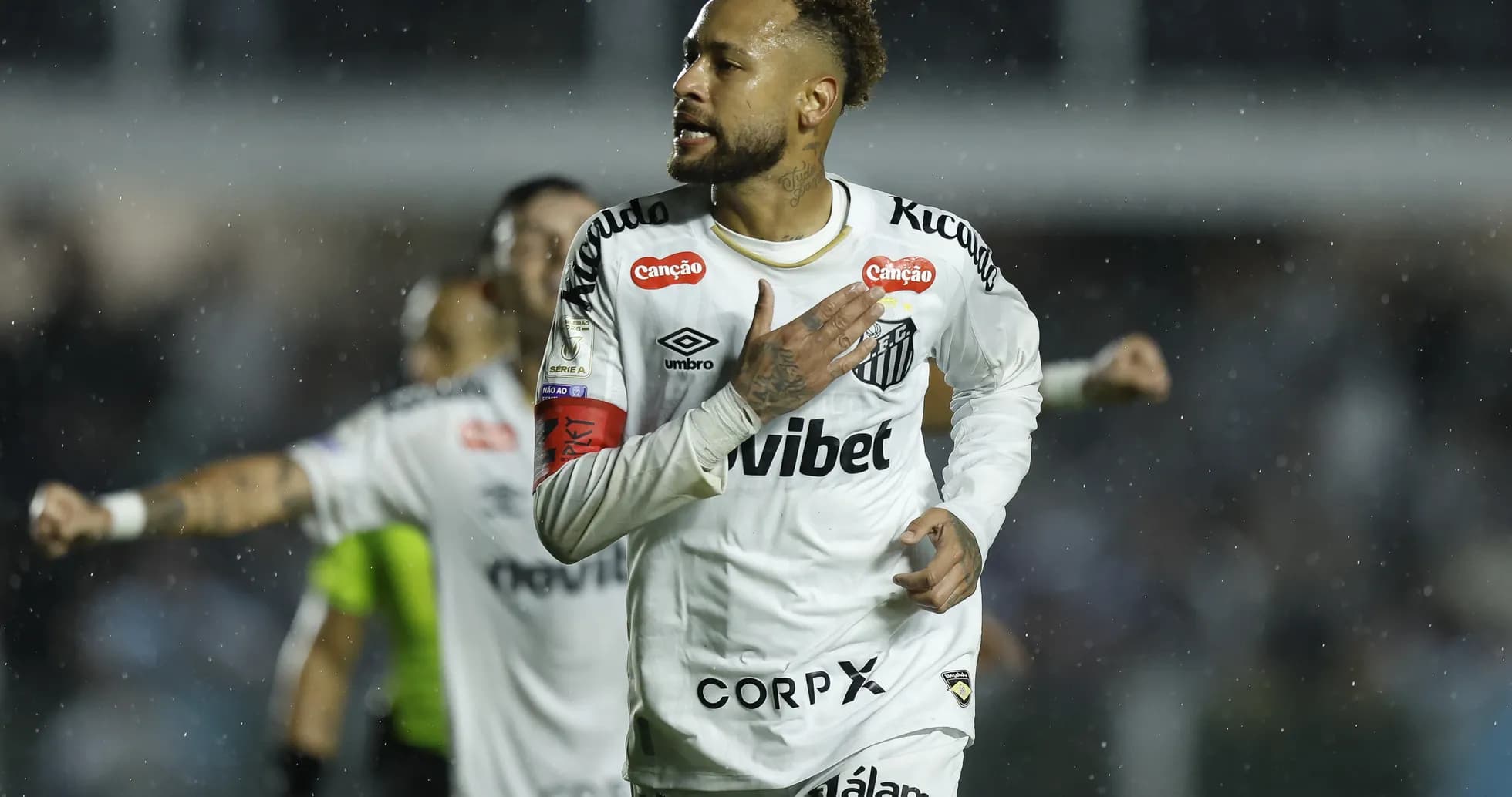 Neymar celebrating a goal for Santos in rain