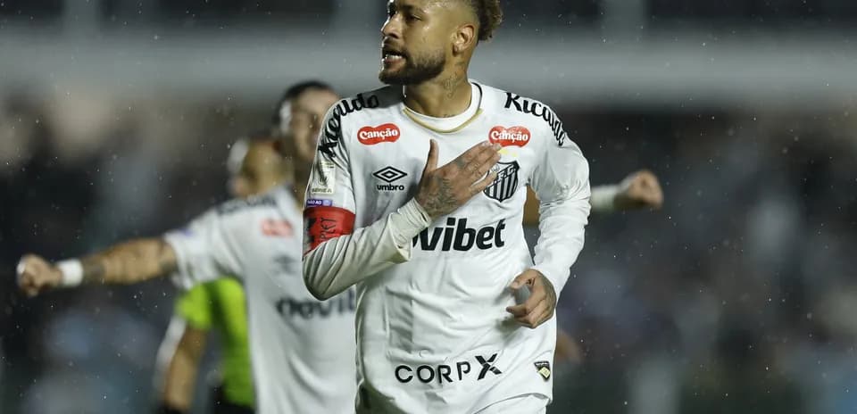 Neymar celebrating a goal for Santos in rain